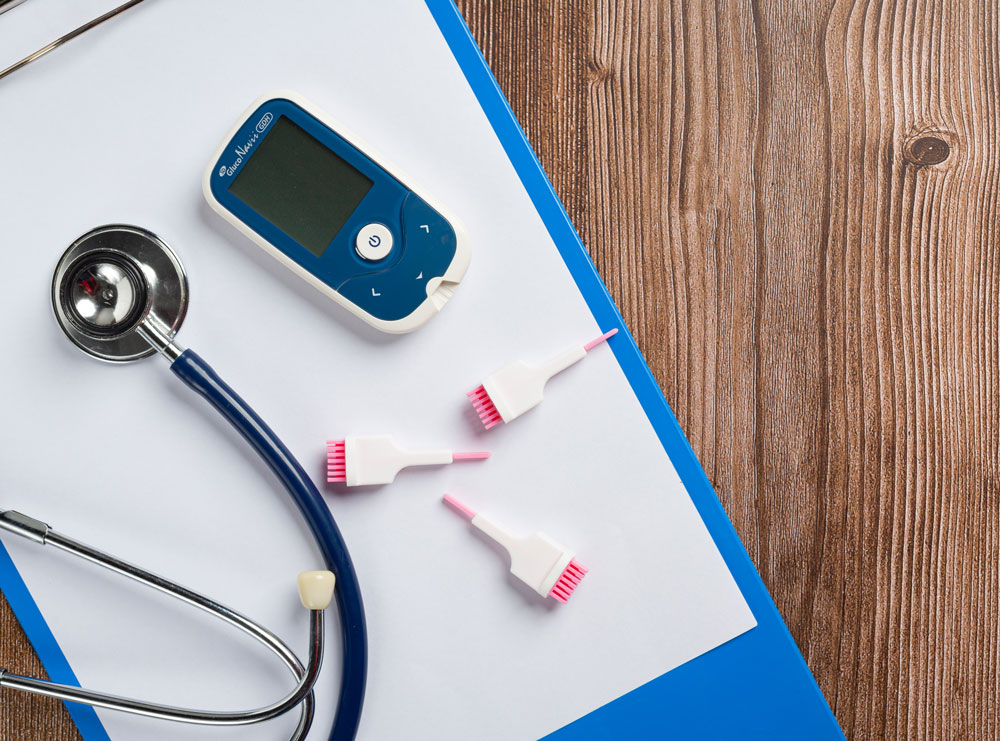 Glucose meter with stethoscope on a clipboard