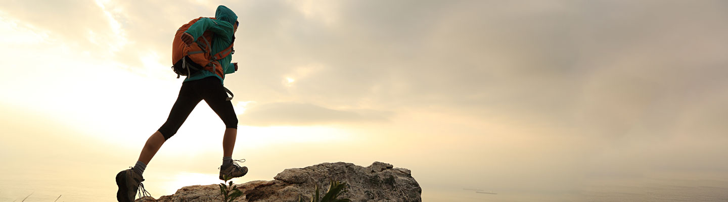 Man hiking to the peak in sports attire